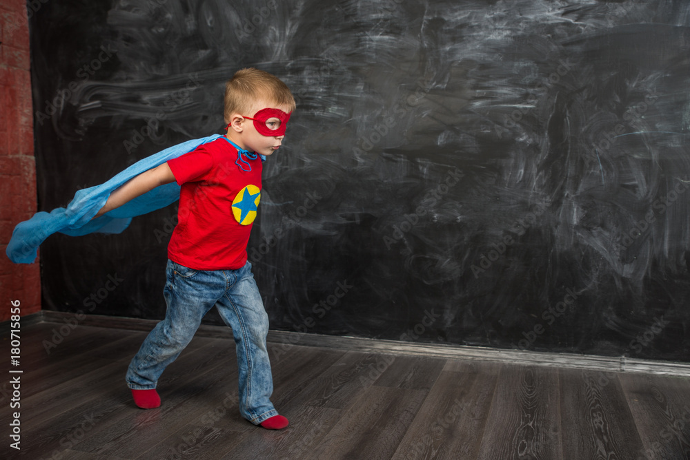 boy superhero in a blue Cape red mask and a red t-shirt with a star boy superhero in a blue Cape red mask and a red t-shirt with a star