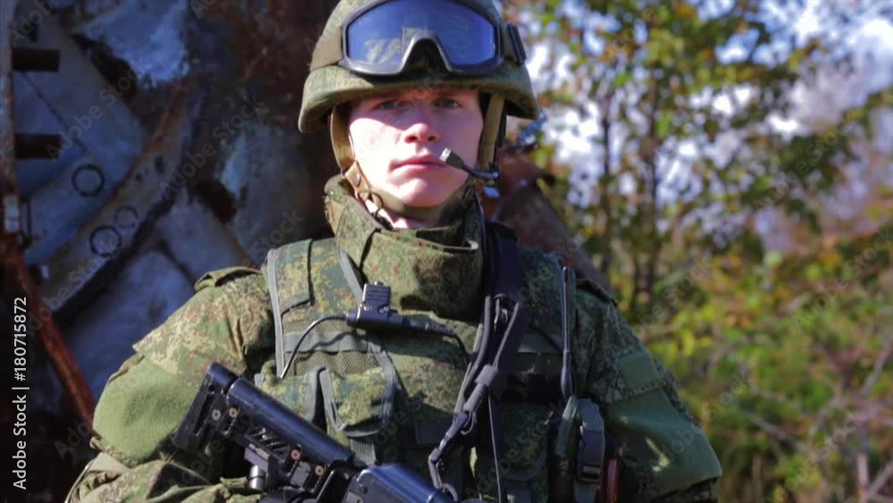 Soldier with modern equipment and AK rifle. Closeup. Front view Soldier with modern equipment and AK rifle. Closeup. Front view