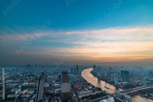 Aerial view of Bangkok cityscape with Chao Phraya river at sunset