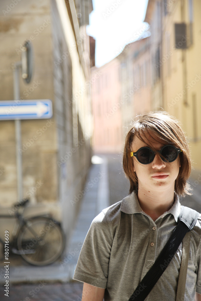 Portrait of a teenager in sunglasses on a city street Portrait of a teenager in sunglasses on a city street