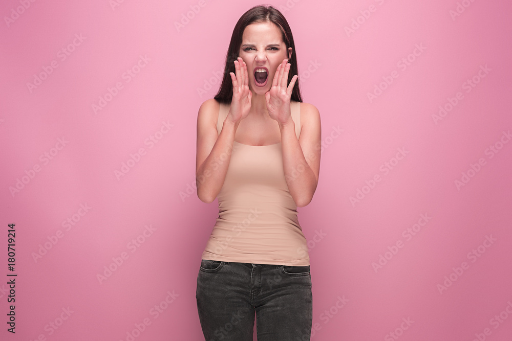 Frustrated young woman screaming at studio Frustrated young woman screaming at studio