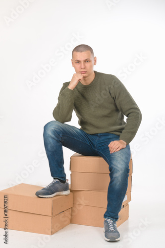 Billede på lærred A young man is skinhead in a green military style sweater