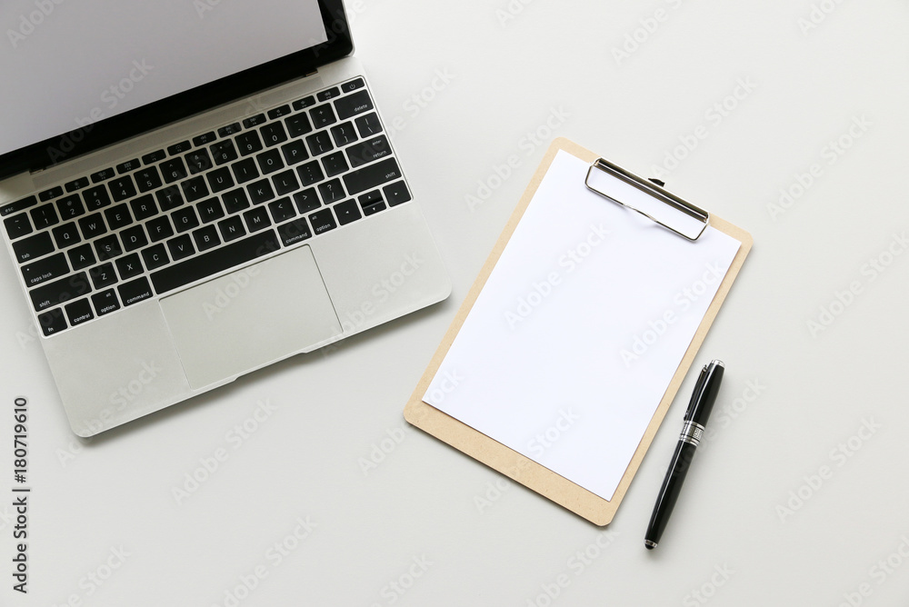 Office table with Laptop computer,pen and Clipboard copy space,Top view, flat lay Office table with Laptop computer,pen and Clipboard copy space,Top view, flat lay