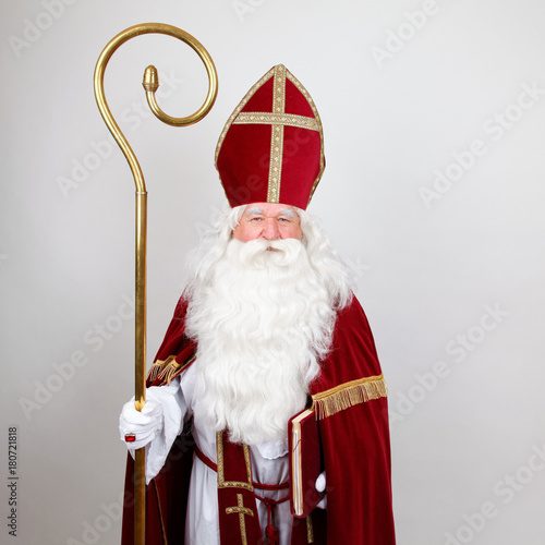 Saint Nicholas standing with his big book and staff photo