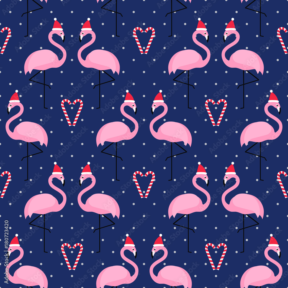 Naklejka premium Flamingo in xmas hat with candy cane heart seamless pattern on blue polka dots background. Exotic New Year background. Christmas design for fabric, wallpaper, textile and decor.