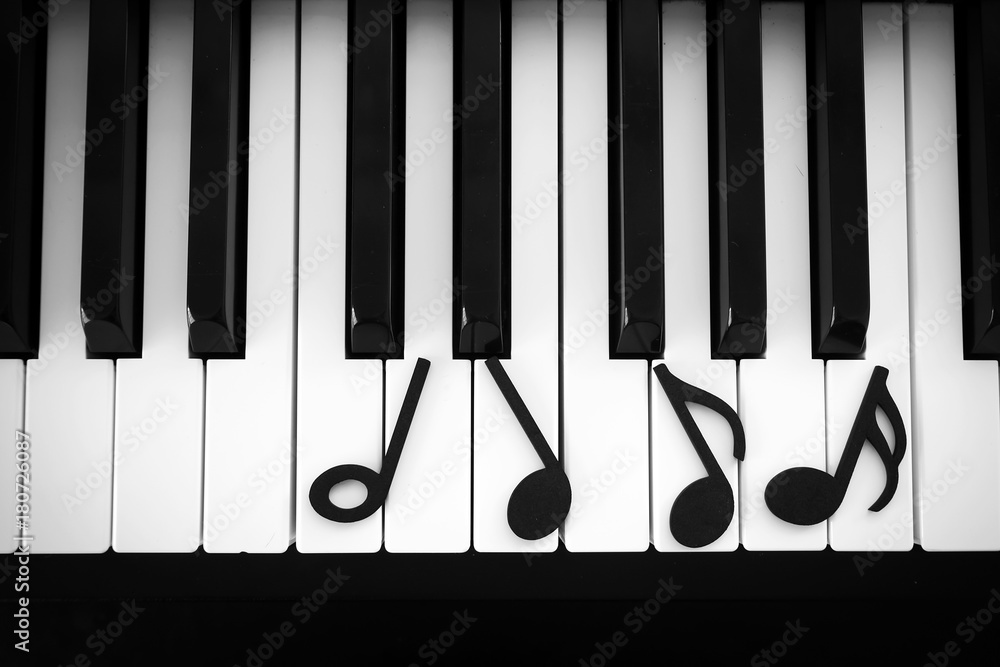 Black note music on piano keyboard. Art and abstract background. Top view.  Black and white theme. Stock Photo | Adobe Stock