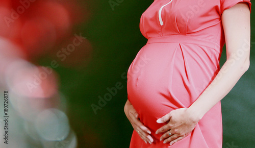 A pregnant woman rests for a beautiful tummy. 