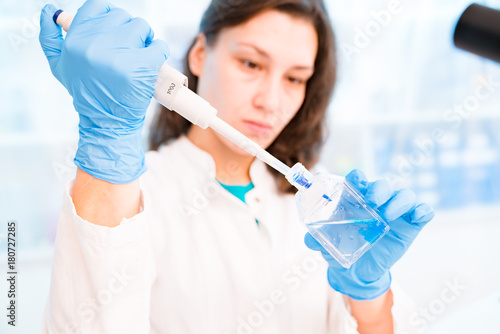 Young woman in microbiological laboratory