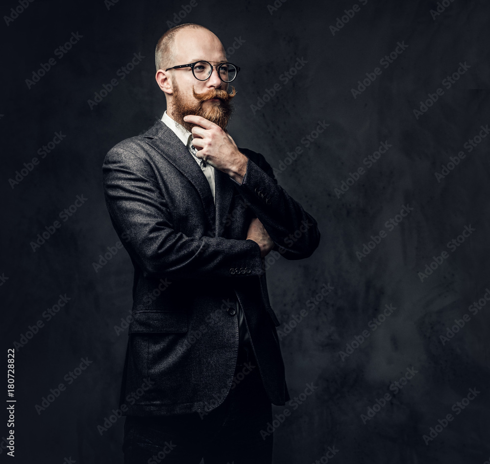 Redhead bearded male in a suit.