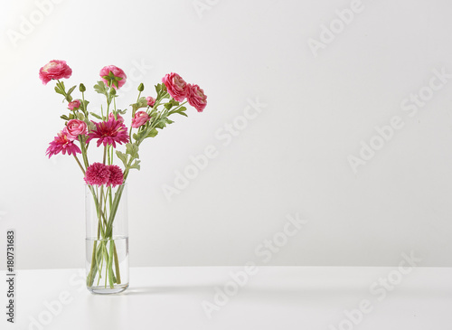 decorative red flowers vase and white background © UnitedPhotoStudio