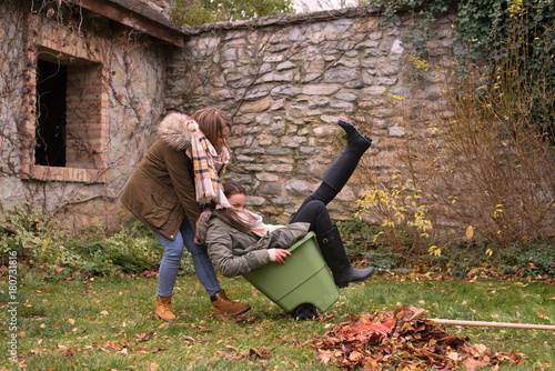 Sisters having fun while doing autumn garden works