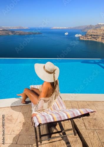 Woman enjoying relaxation in pool and looking at the view