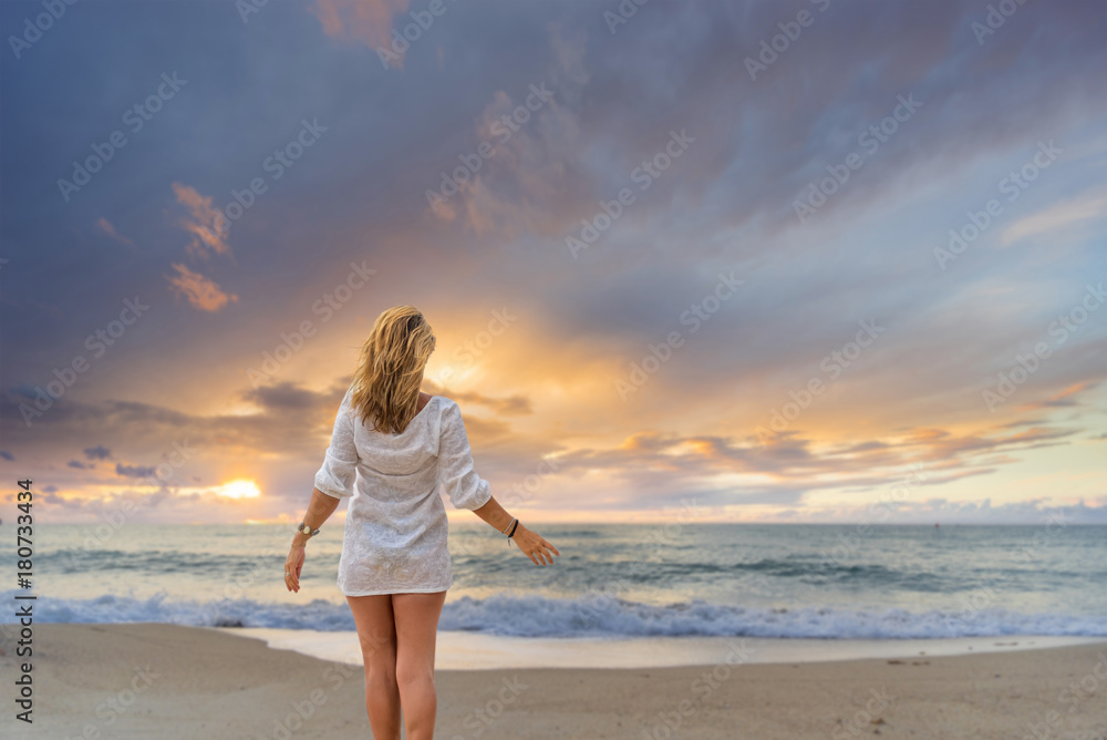 Woman on the beach at sunset in Asia