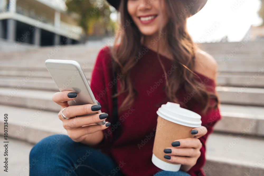 Cropped image of smiling brunette woman in hat and sweater Cropped image of smiling brunette woman in hat and sweater