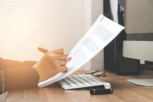 Business woman reading document paper on working table