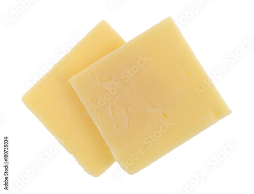Top view of two slices of a sharp cheddar cheese squares isolated on a white background.