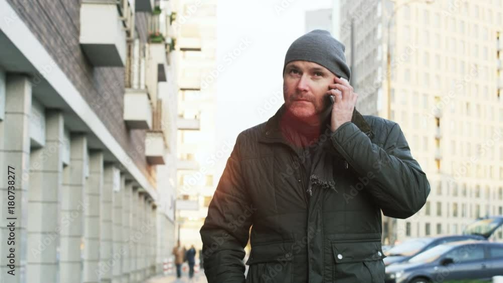 Middle-Aged Man Starting a Phone Call in the Street Middle-Aged Man Starting a Phone Call in the Street