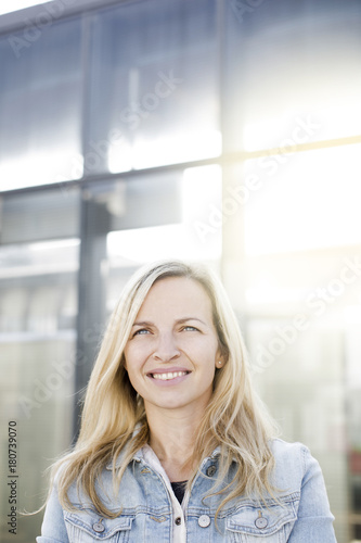 Free Download modern young business woman in casual look in front of glass building - GFXLoad