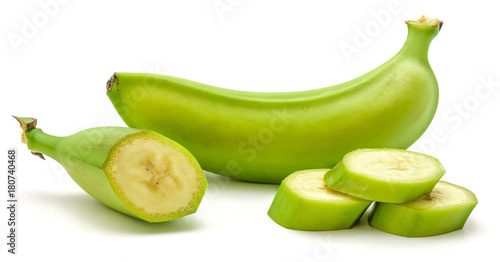 One whole plantain and three slices isolated on white background.