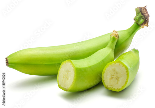 One whole and two halves of plantain isolated on white background green banana.