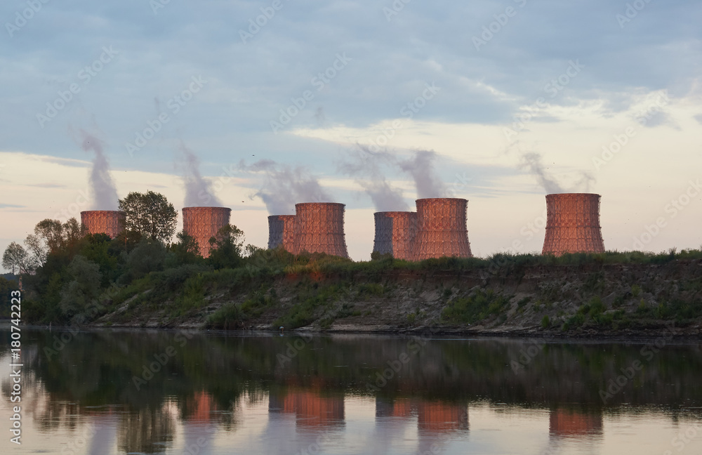 Cooling towers of a nuclear power plant on the river bank. Cooling towers of a nuclear power plant on the river bank.