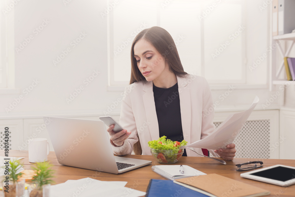 Young business woman eating salad at office Young business woman eating salad at office