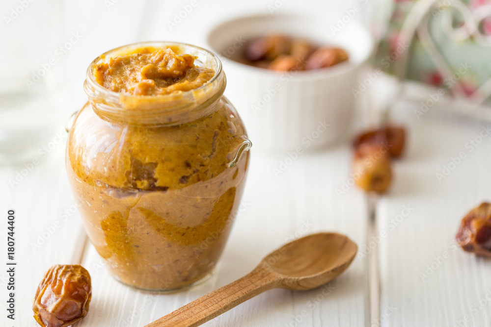 Date Caramel Sauce on Light Wooden Table, Horizontal View Date Caramel Sauce on Light Wooden Table, Horizontal View