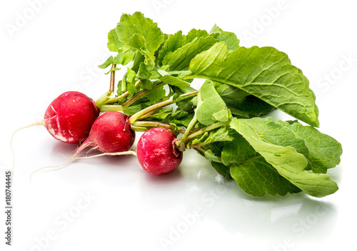 Three whole red radish with fresh green leaves isolated on white background.