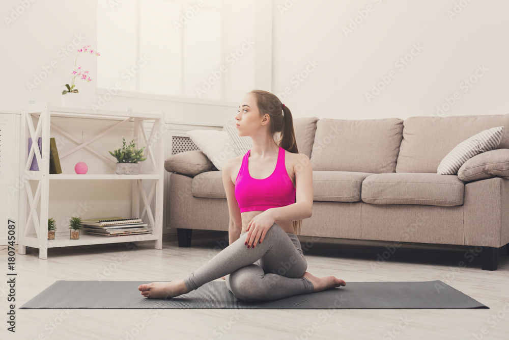 Woman training yoga in twisting sage pose. Woman training yoga in twisting sage pose.