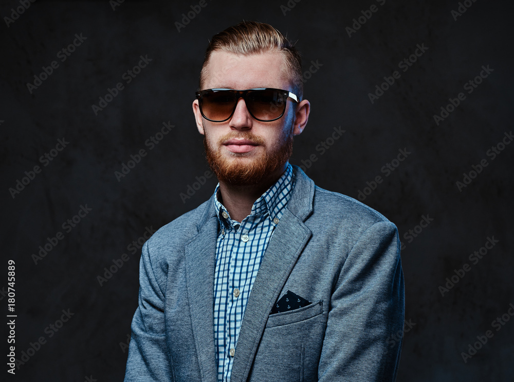 A man dressed in a suit and sunglasses. A man dressed in a suit and sunglasses.