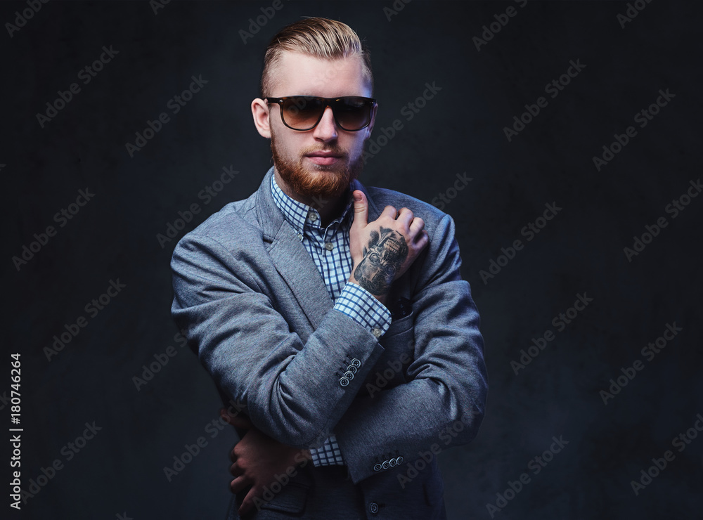 A man dressed in a suit and sunglasses.