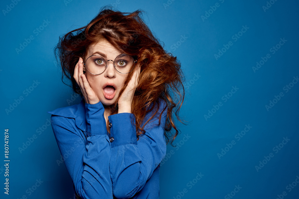 girl with brown hair in glasses on a blue background girl with brown hair in glasses on a blue background