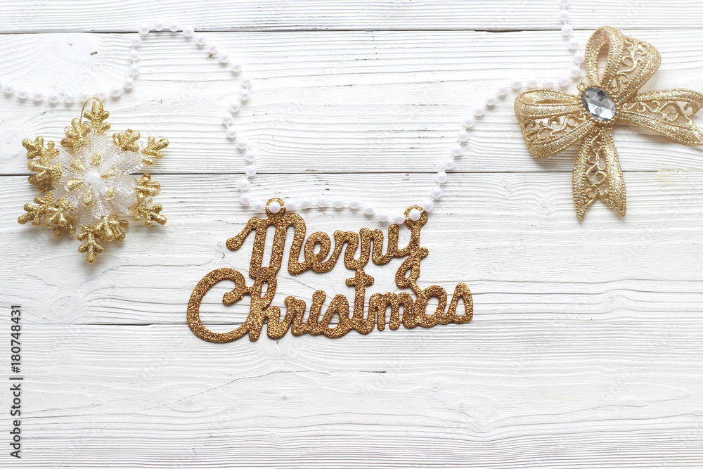 holiday decorations and inscription: Merry Christmas on white wood background and copy space, top view