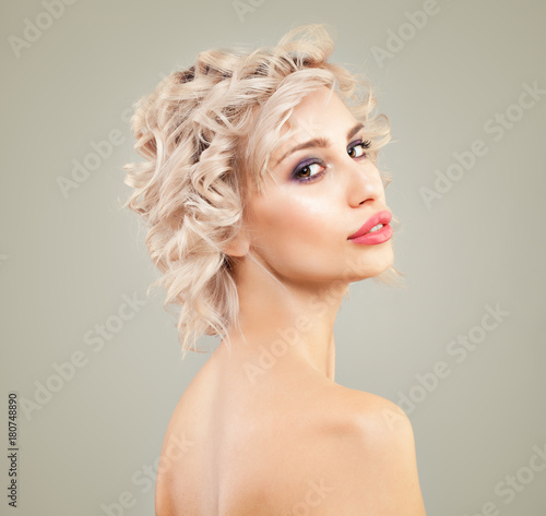 Beautiful Blonde Woman with Wavy Bob Hairstyle and Makeup on Background