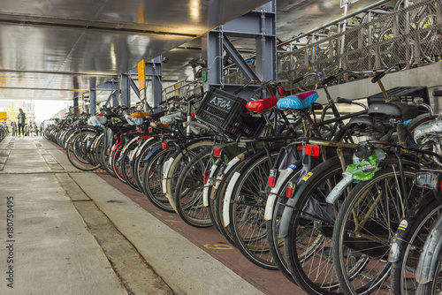 AMSTERDAM, NETHERLANDS - SEPTEMBER 24, 2017: Parking of bicycles in Amsterdam city. Amsterdam, Netherlands.. © resul