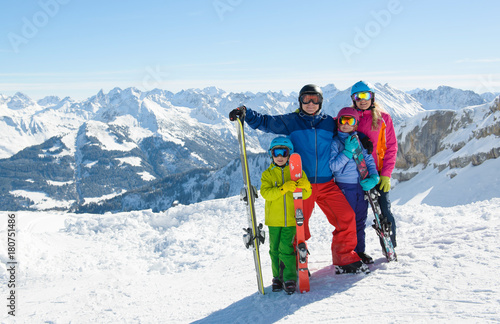 Happy family enjoying winter vacations in mountains . Ski, Sun,Snow and fun.