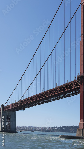 Vertical section of the suspension and cropped view of south tower of the iconic Golden Gate Bridge, San Francisco, California, USA