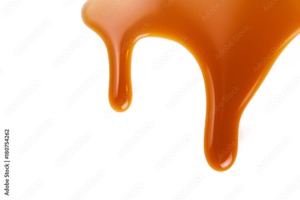 Flowing caramel sauce isolated on white background. Golden Butterscotch toffee caramel liquid . Flowing caramel sauce isolated on white background. Golden Butterscotch toffee caramel liquid .