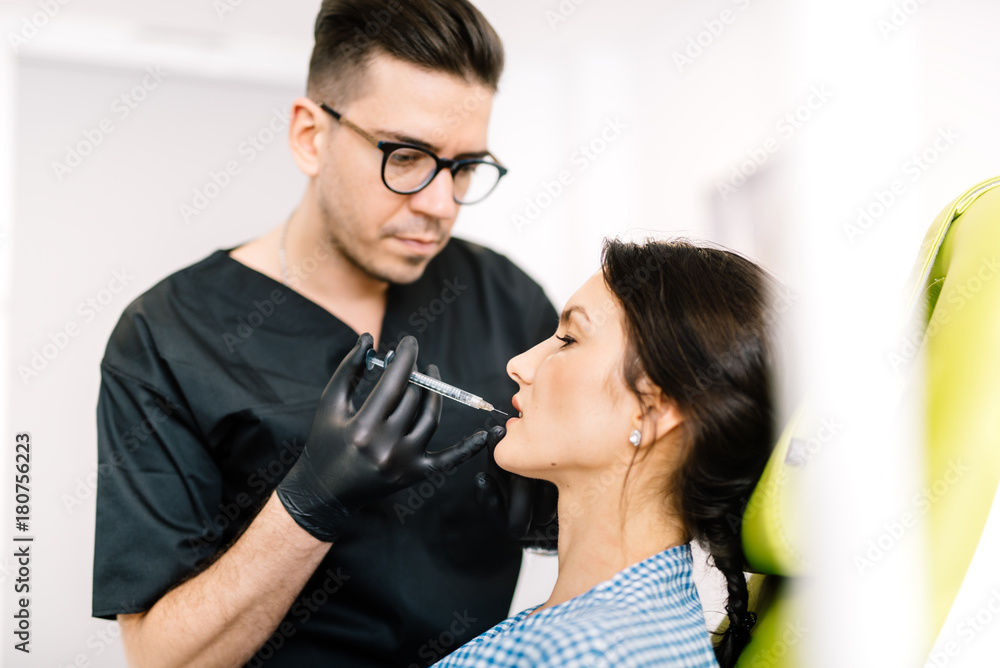 Professional doctor performing lip surgery using hyaluronic acid Professional doctor performing lip surgery using hyaluronic acid