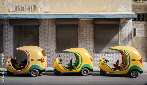 Small cuban coco taxis in line