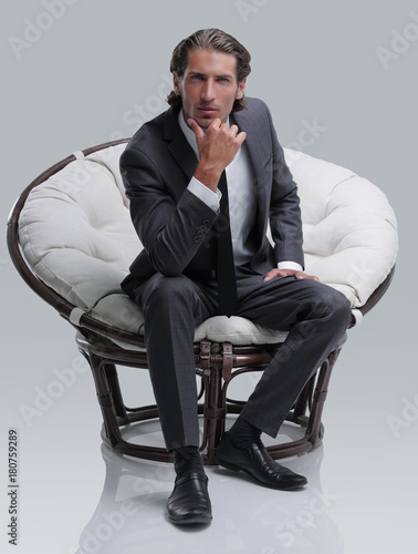 confident businessman sitting in chair © ASDF