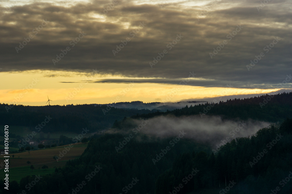 Warm sunset above the black forest covered with fog in autumn near Freiburg