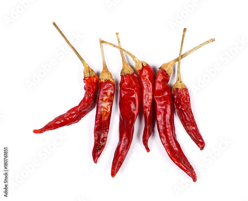 Dry red hot chili peppers, pile isolated on white background, top view