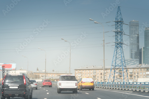 high speed road cars in the background of high voltage towers