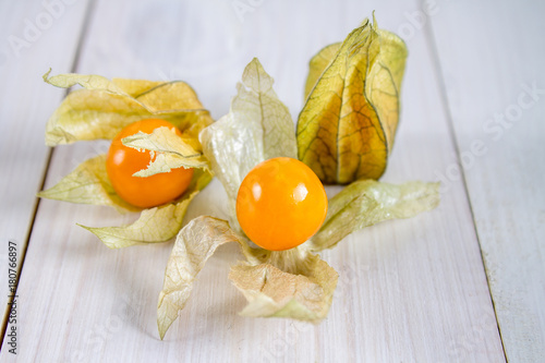 Exotic berries physalis on a white wooden table. photo