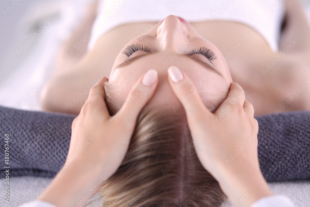 Young woman lying on a massage table,relaxing with eyes closed. Woman. Spa salon Young woman lying on a massage table,relaxing with eyes closed. Woman. Spa salon
