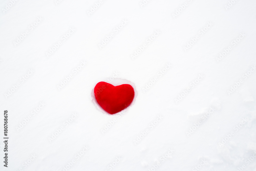 Red plush heart abandoned on white snow. Red plush heart abandoned on white snow.