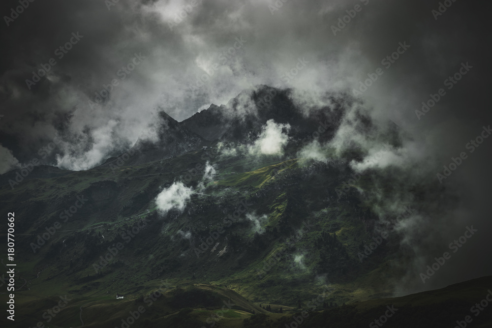 Dark, cloud shrouded landscape and mountain range Dark, cloud shrouded landscape and mountain range