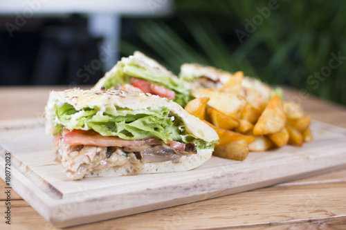 Sandwich with grilled chicken and vegetables. Shawarma from juicy beef, lettuce, tomatoes, cucumbers, paprika and onion in pita bread.