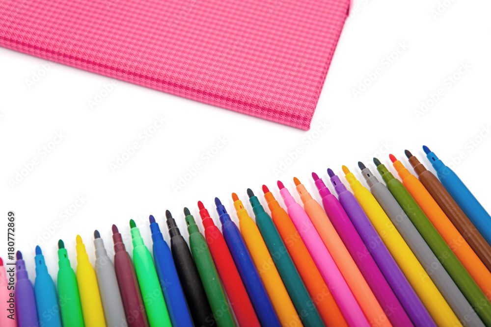 Fototapeta premium Notebook and multicolored markers on a white background